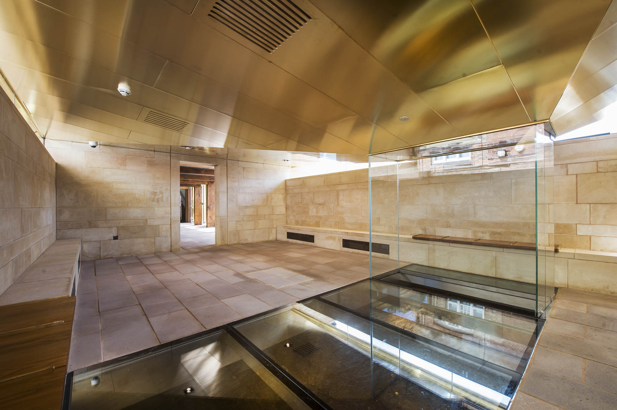 a room with a glass and stone floor